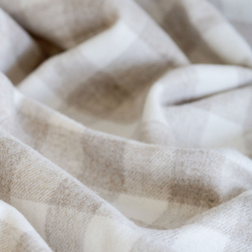 Close-up of a textured beige fabric with a subtle pattern