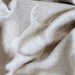 Close-up of beige fabric with subtle texture