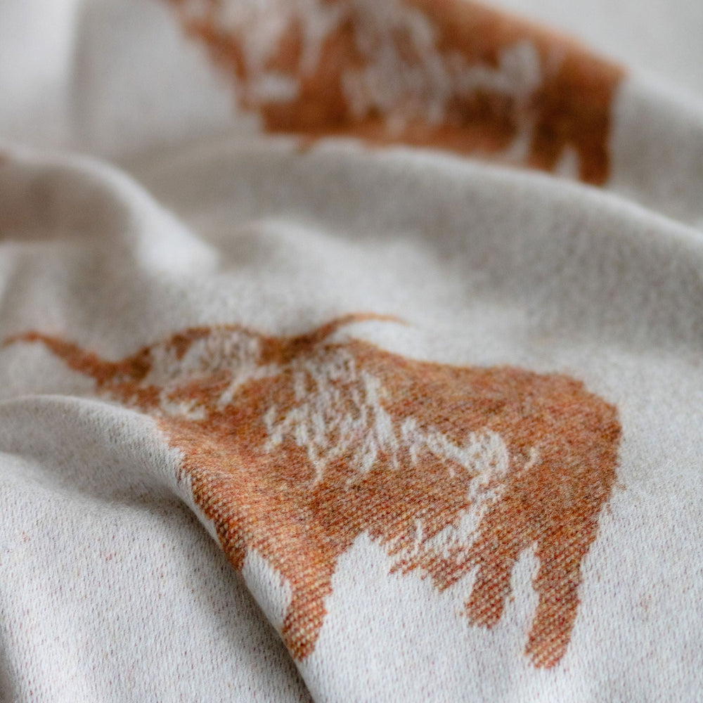 Close-up of fabric with brown abstract patterns on a white background