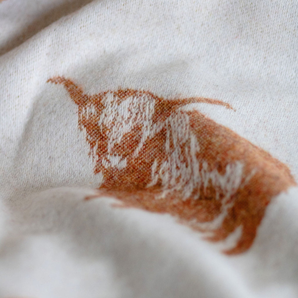 Close-up of fabric with brown abstract patterns on a white background