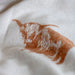 Close-up of fabric with brown abstract patterns on a white background