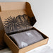Open cardboard box containing a horse patterned wool blanket.