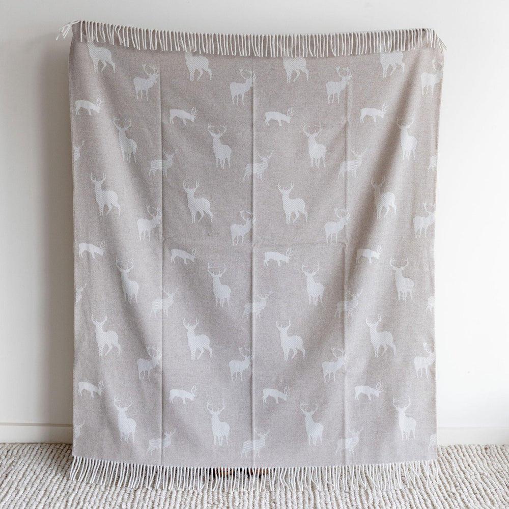 Gray blanket with white animal pattern on a light gray background