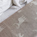 Gray blanket with animal pattern on a bed