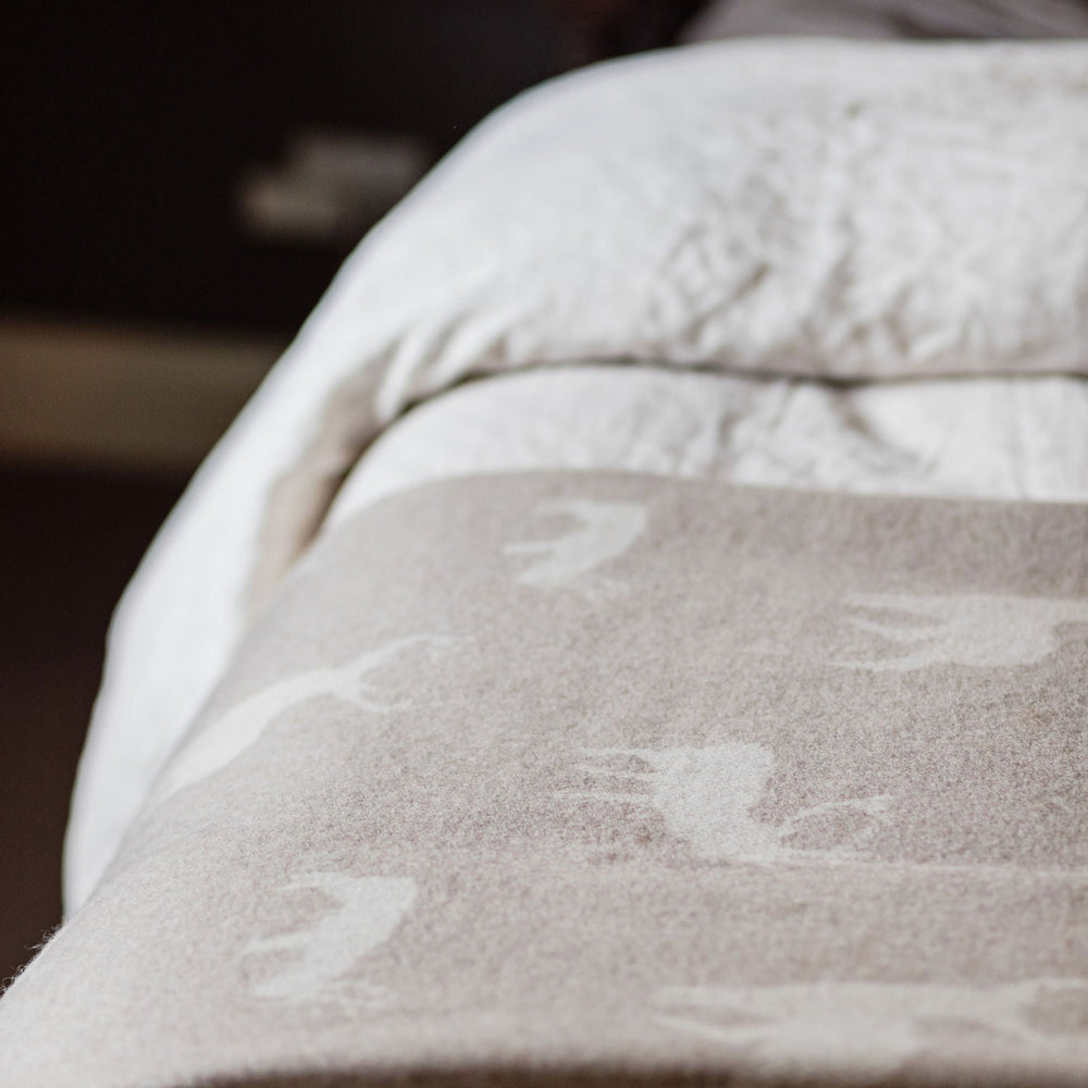 Close-up of a textured blanket with floral patterns on a soft surface.